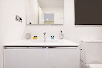 Bathroom with built-in mirror, white vanity with drawers and resin sink and methacrylate accessories