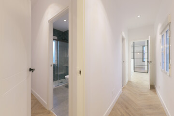 Corridors of a house with access to several rooms with wood-like stoneware floors