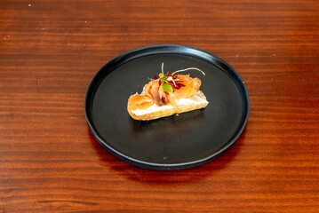 A delicious pincho served in a Spanish restaurant with cream cheese and Norwegian salmon