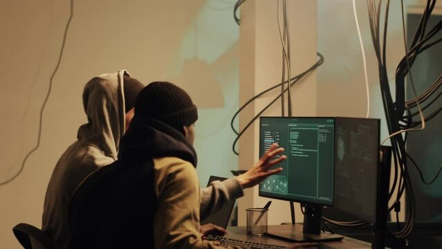 Skilled web thief hacking network with digital espionage concept, stealing important government information. Male hacker working with trojan virus to hack firewall, doing cyberattack.