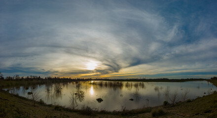 Sunset reflecting on flooded land next to levee
