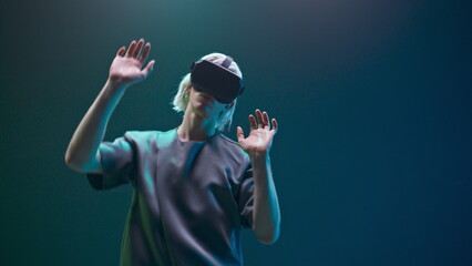 Closeup esport gamer dancing metaverse. Millennial man relaxing with 3d headset