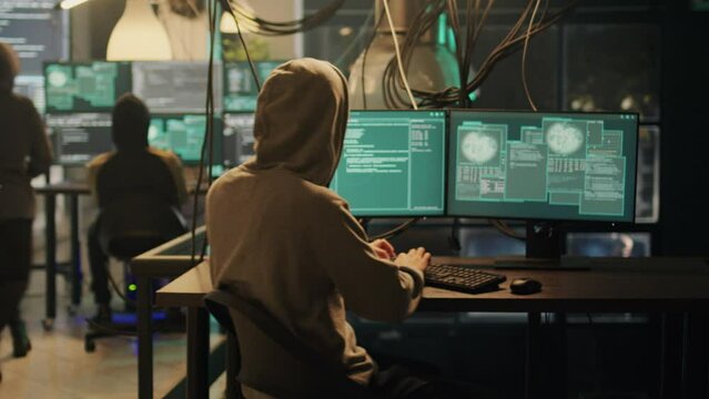 Hackers team trying to steal government information at night, planting trojan virus to manipulate network system. Criminals doing cyber attack and illegal activities, dark web espionage.