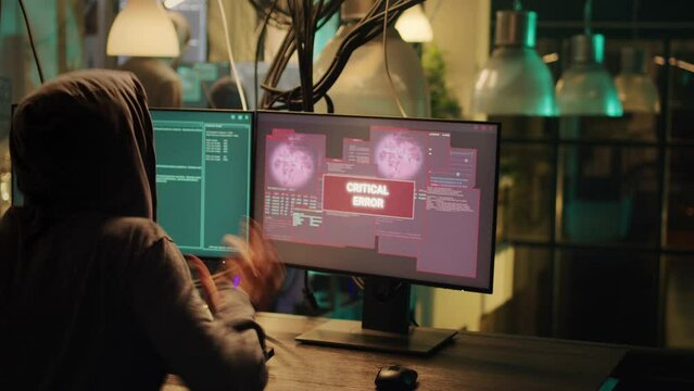 Cheerful man celebrating espionage achievement on monitors, feeling happy about stealing passwords at night. Skilled hacker enjoying cyberattack success with malware to break firewall.