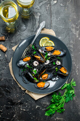 Mediterranean food. Spaghetti with cuttlefish ink, clams and white wine.