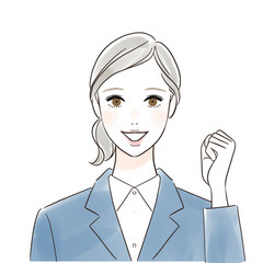 笑顔でガッツポーズするスーツ姿の女性会社員