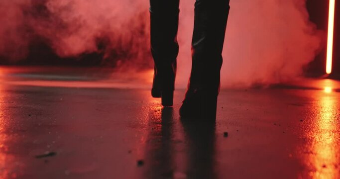 woman running through fog on a wet road. slow-motion footage
