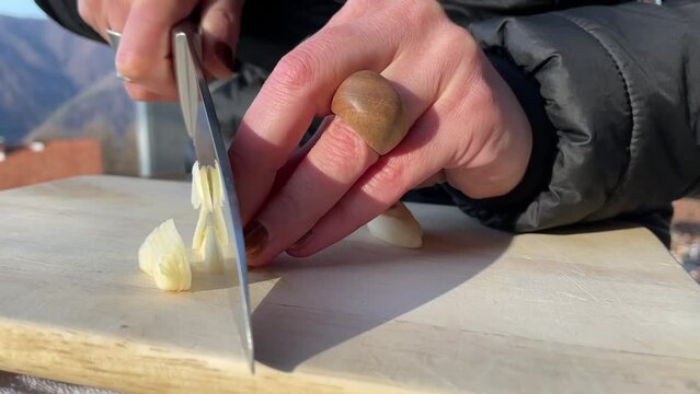 Chopping garlic on a wooden board
