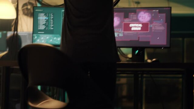 Skilled spy celebrating hacking achievement with security breach, attacking goverment system with encryption. Hacker committing identity theft, cryptojacking ransomware. Handheld shot.