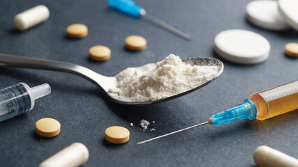 Different hard drugs on black background, closeup