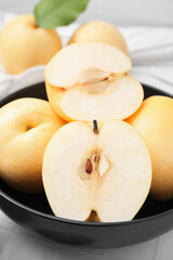 Naklejka na ściany i meble Delicious apple pears on white tiled table, closeup