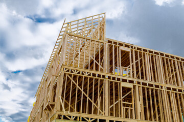 New residential construction home framing against a blue sky roofing construction wooden...