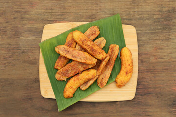 Delicious fried bananas on wooden table, top view