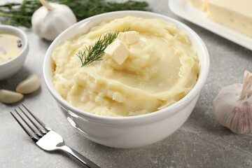 Delicious mashed potato with dill served on light grey table