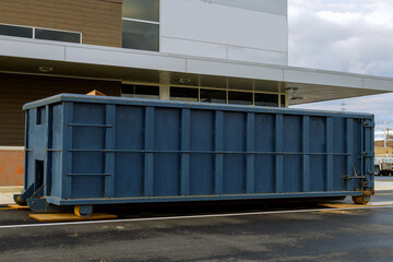 Metal trash construction garbage dumpster on the house renovation