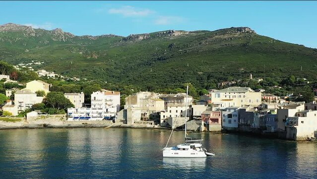 The city of Erbalunga in the middle of the arid and green mountains, in Europe, in France, in Corsica, towards Bastia, by the Mediterranean Sea, in summer, on a sunny day.