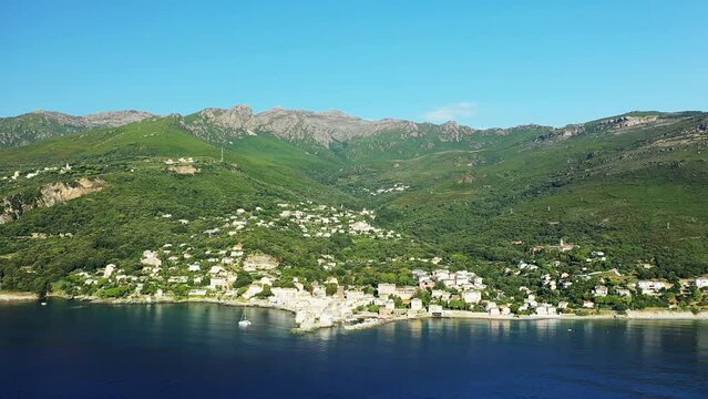 The city of Erbalunga in the middle of the arid and green mountains, in Europe, in France, in Corsica, towards Bastia, by the Mediterranean Sea, in summer, on a sunny day.