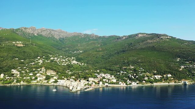 The city of Erbalunga in the middle of the arid and green mountains, in Europe, in France, in Corsica, towards Bastia, by the Mediterranean Sea, in summer, on a sunny day.