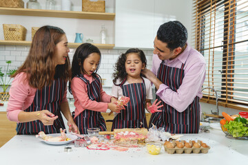 happy family funny kids are cooking the dough, baking cookies in the kitchen, Homemade food, and little helper.