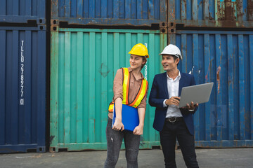 two engineer worker hold a laptop, document for checking a quality of containers box from cargo ship for export and import, blue container background