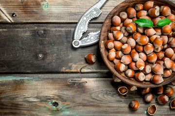 Hazelnuts in a bowl with a Nutcracker.