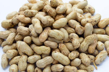 Raw peanuts on white background.