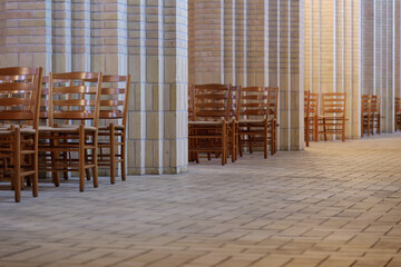 Selective focus view at row of chairs without people for worshipper beside aisle corridor of Protestant Church. 