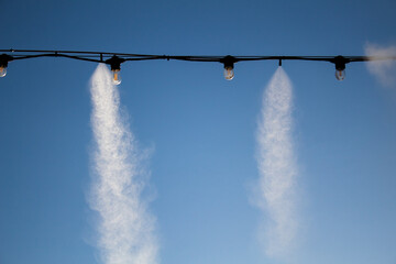 Outdoor misting system at gateway alt lake city cools people down. Restaurant terrace outdoor...