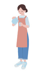 コップに水を注ぐエプロン姿の女性