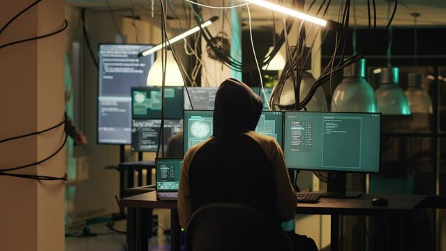 Hackers trying to steal online data late at night, planting virus and malware to manipulate computer system. Criminals doing cyber crime and illegal activities, dark web espionage. Tripod shot.