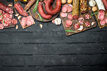 Different types of salami on wooden Board.