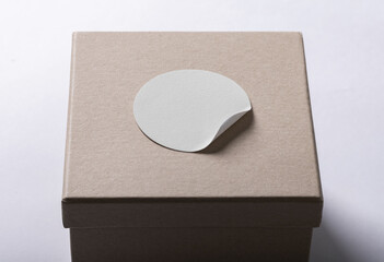 Rounded sticker mockup template on box package with copy space for your logo or graphic design