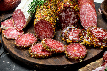 Assortment of different salami with spices and herbs.