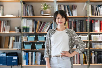 Contemporary Asian Woman architect or interior designer looking at camera during work in office