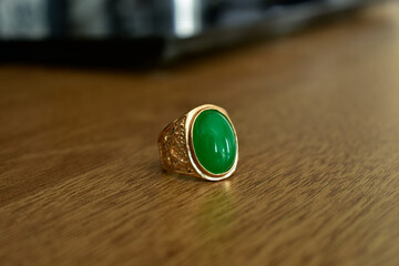 The jade ring is a gold ring decorated with green jade.