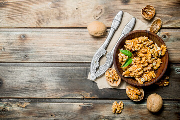Obraz na płótnie Canvas Shelled walnuts with a Nutcracker.