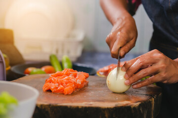 Closeup of Human hands cooking salmon menu in kitchen at home. 