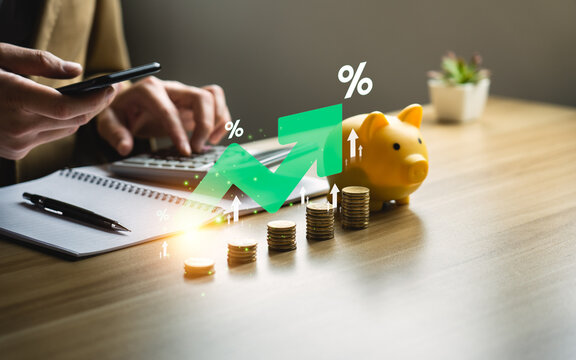 higher interest rates and dividends, pile of coins and percentage of company profits. saving money for Invest in growth and pay out dividends, cash reserves.compensation fund for retirement