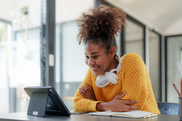 Young black curly hair American African woman using digital tablet