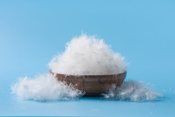  white down feathers on blue background. © zhikun sun