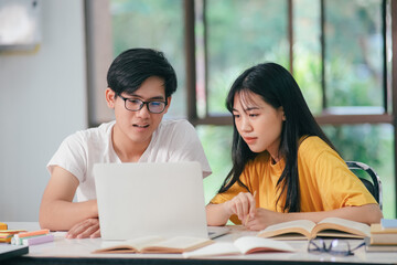 Young Asian students read together with friends. learn together with friends.