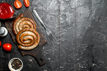 Grill sausages with tomato sauce and spices.
