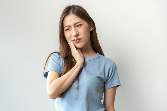 Face Expression Suffering From Sensitive Teeth And Cold, Asian Young Woman, Girl Feeling Hurt, Pain Touching Cheek, Mouth With Hand. Toothache Molar Tooth, Dental Problem Isolated On White Background.