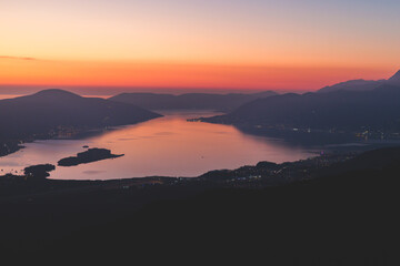 The Bay of Kotor, Beautiful aerial view of Boka Kotorska, with Kotor, Herceg Novi and Tivat municipalities night sunset view, Adriatic sea and Dinaric Alps with Lovcen mountain, Montenegro