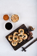 Takoyaki is Japanese Street Food containing with octopus, sausage or cheese. garnish with seaweed and katsuobushi