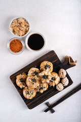 Takoyaki is Japanese Street Food containing with octopus, sausage or cheese. garnish with seaweed and katsuobushi