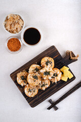 Takoyaki is Japanese Street Food containing with octopus, sausage or cheese. garnish with seaweed and katsuobushi