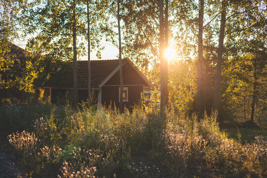 View of classical finnish landscape with traditional wooden red cabin cottage houses and camping site, Uusimaa, Southern Finland in a summer sunny day