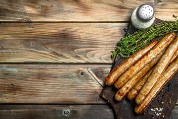 Grilled pork sausage with spices and herbs .