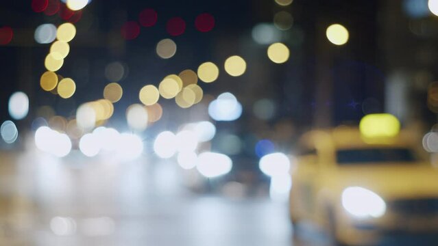Unsharp Traffic Lights of Cars with Bokeh on Streets of Illuminated City